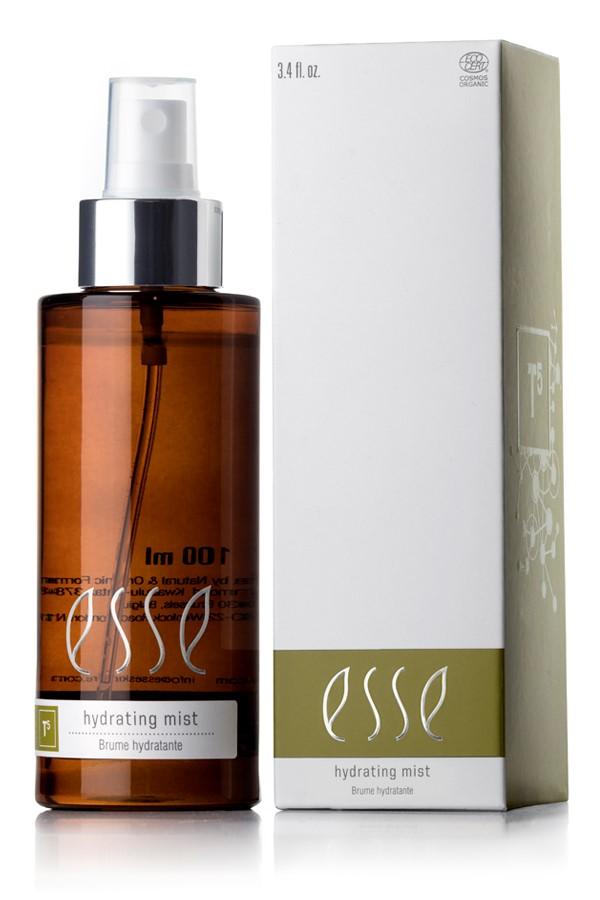 A 100ml brown spray bottle labeled "Esse Hydrating Mist" stands next to its white and green box packaging. The spray bottle features a white pump, and the box showcases identical "Esse Hydrating Mist" text along with additional branding and product information.