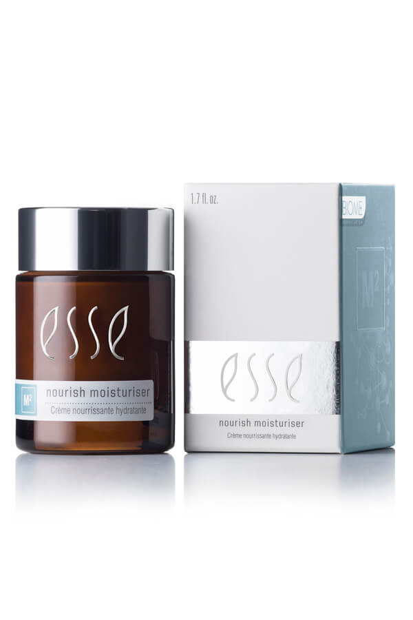 A brown jar with a black lid labeled "Esse Nourish Moisturiser" is next to a white and blue box with the same branding. The jar is 1.7 fl. oz. (50 ml) in size.